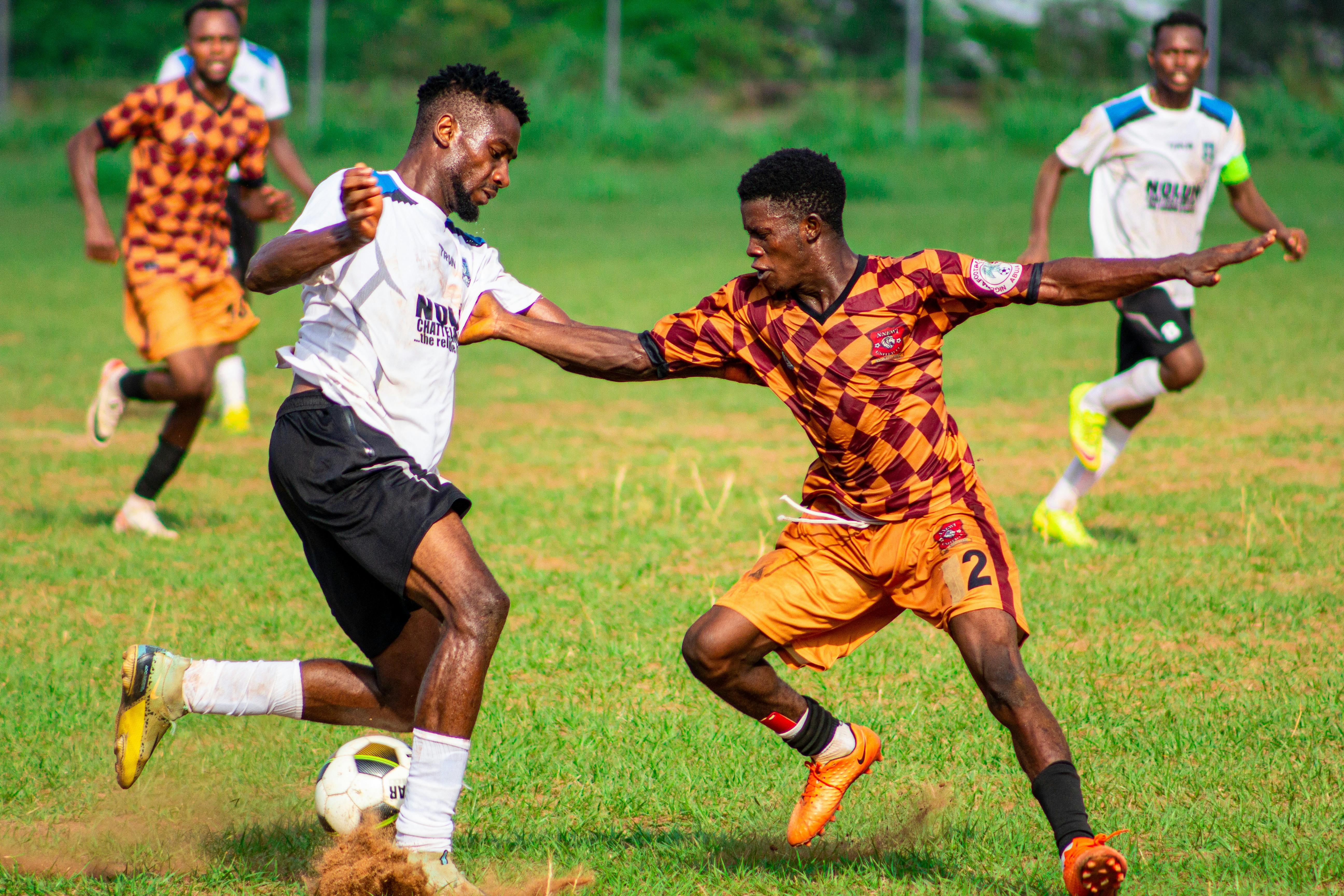 Players in action during a competitive soccer match outdoors.