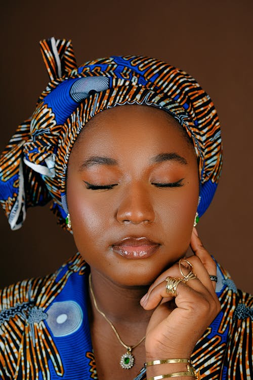 A woman with a blue and orange head wrap