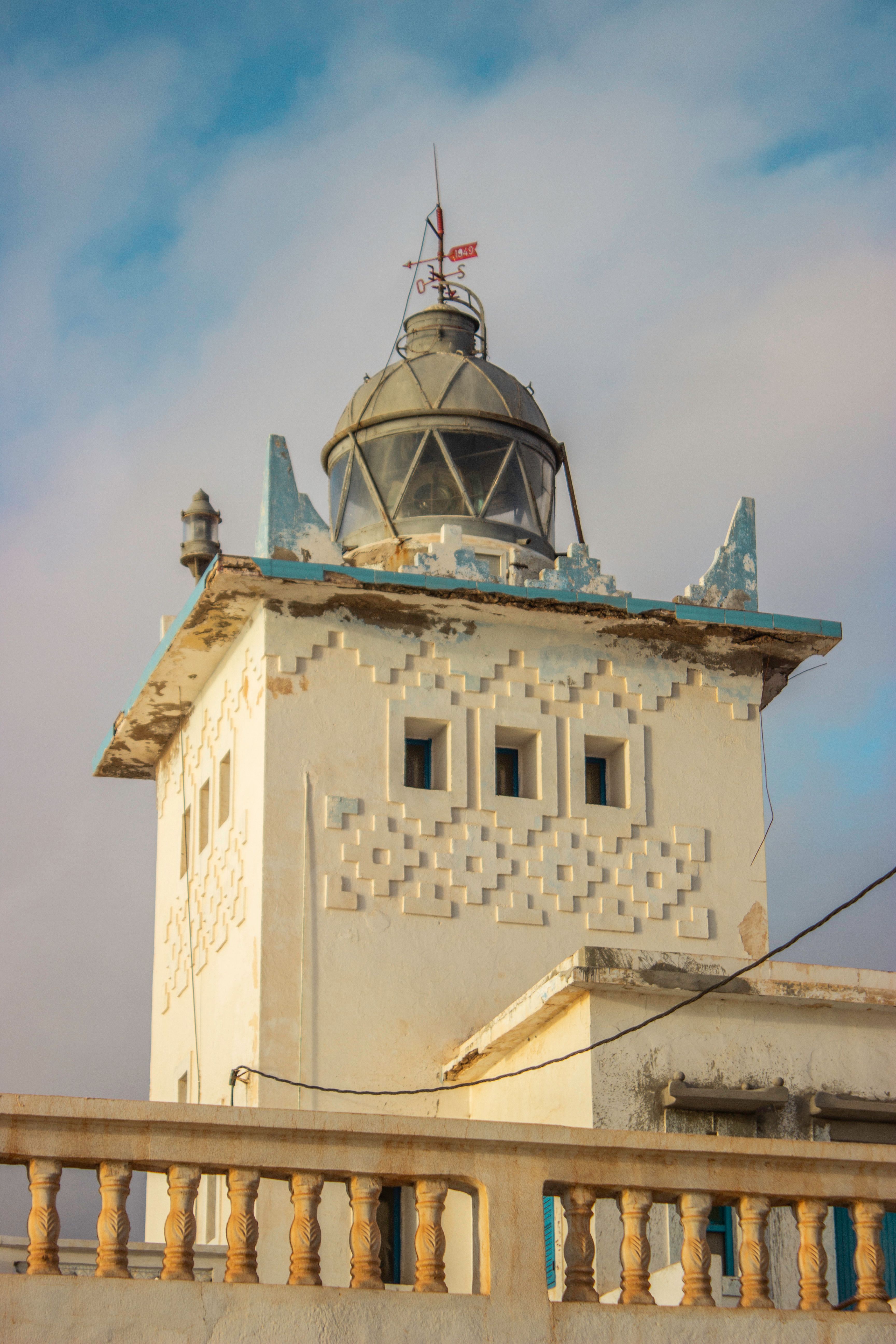 Capture of Sidi Ifni Lighthouse showcasing distinctive Moroccan architecture under a clear sky.