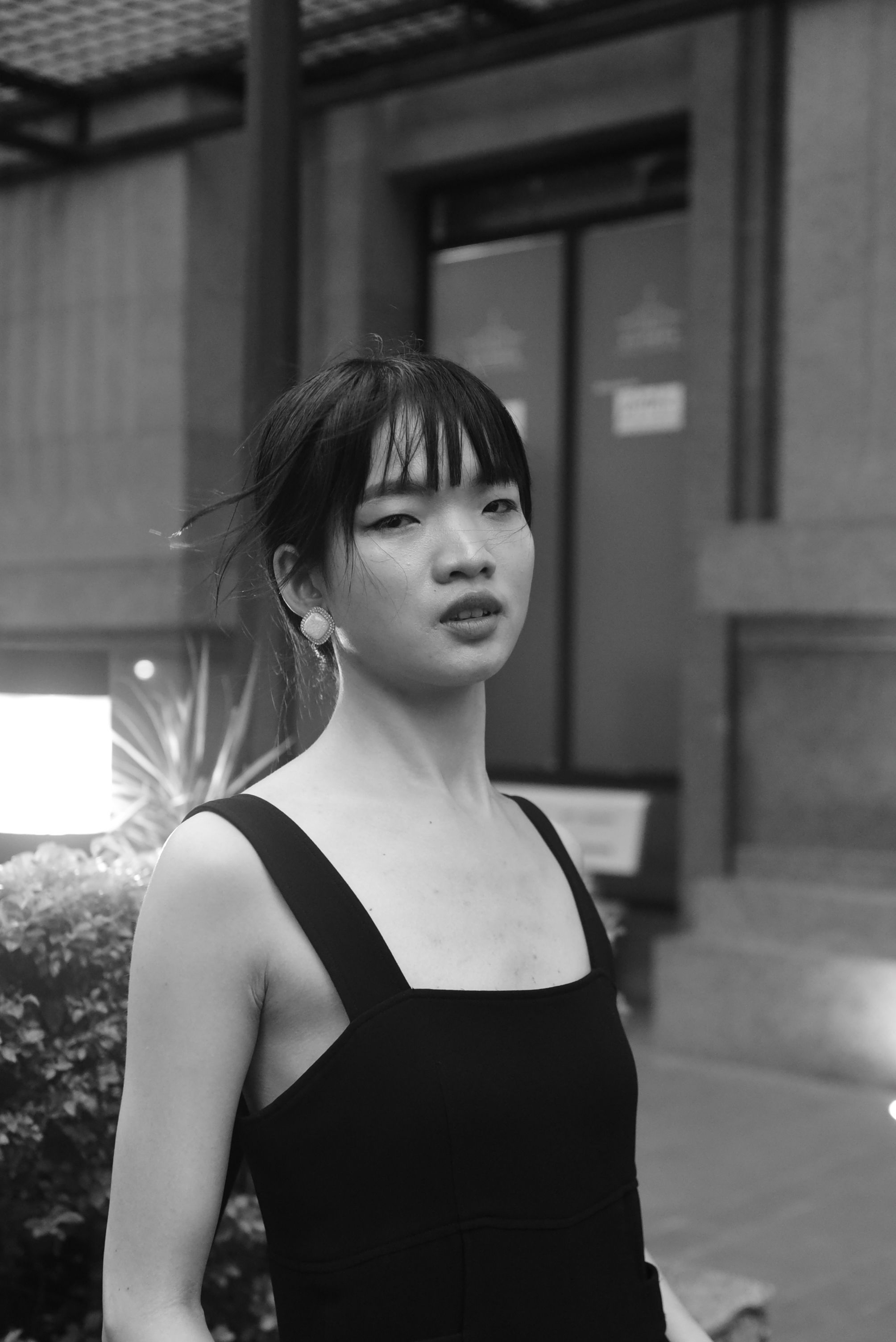 A woman in a black dress standing outside · Free Stock Photo