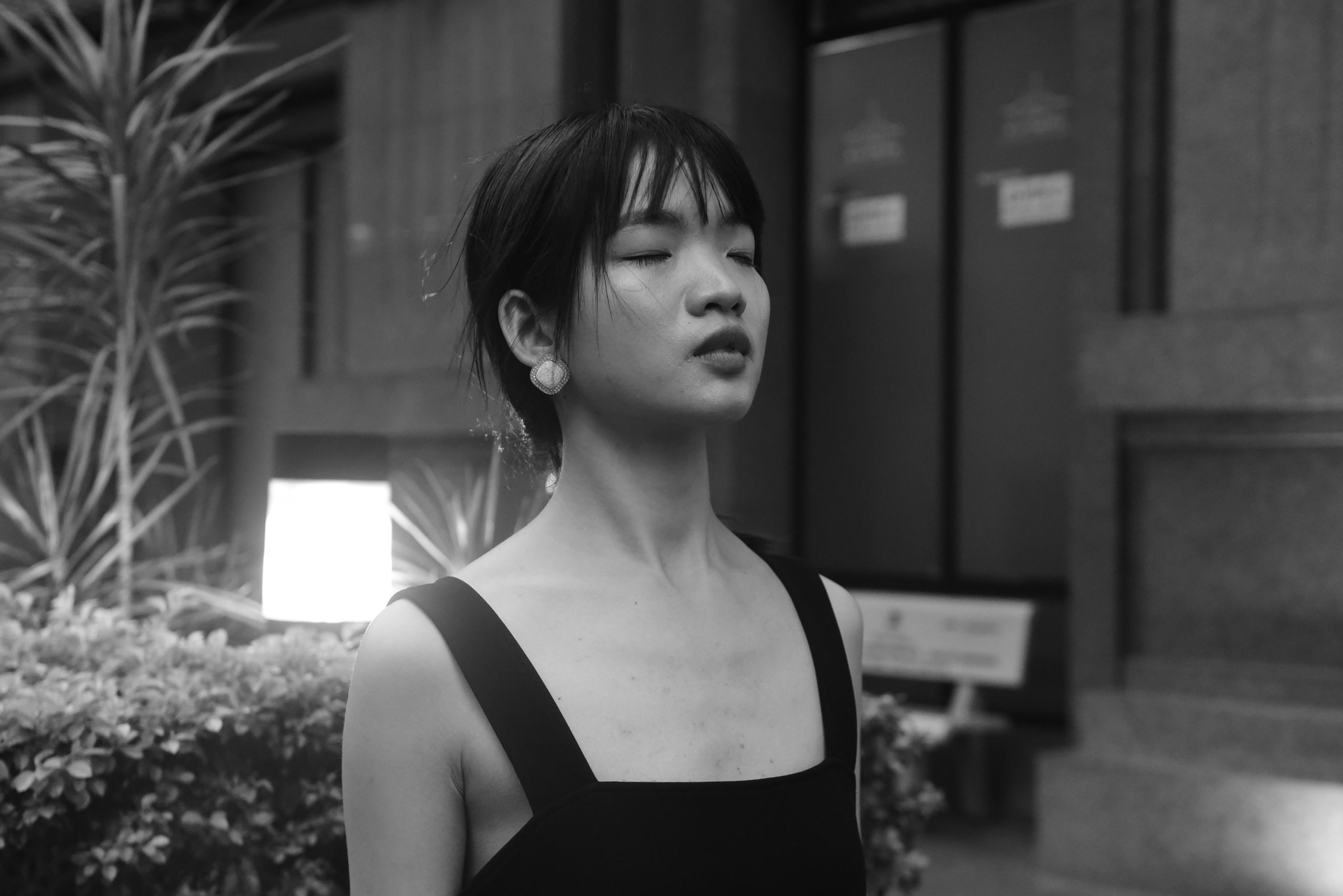 A woman in a black dress standing outside · Free Stock Photo