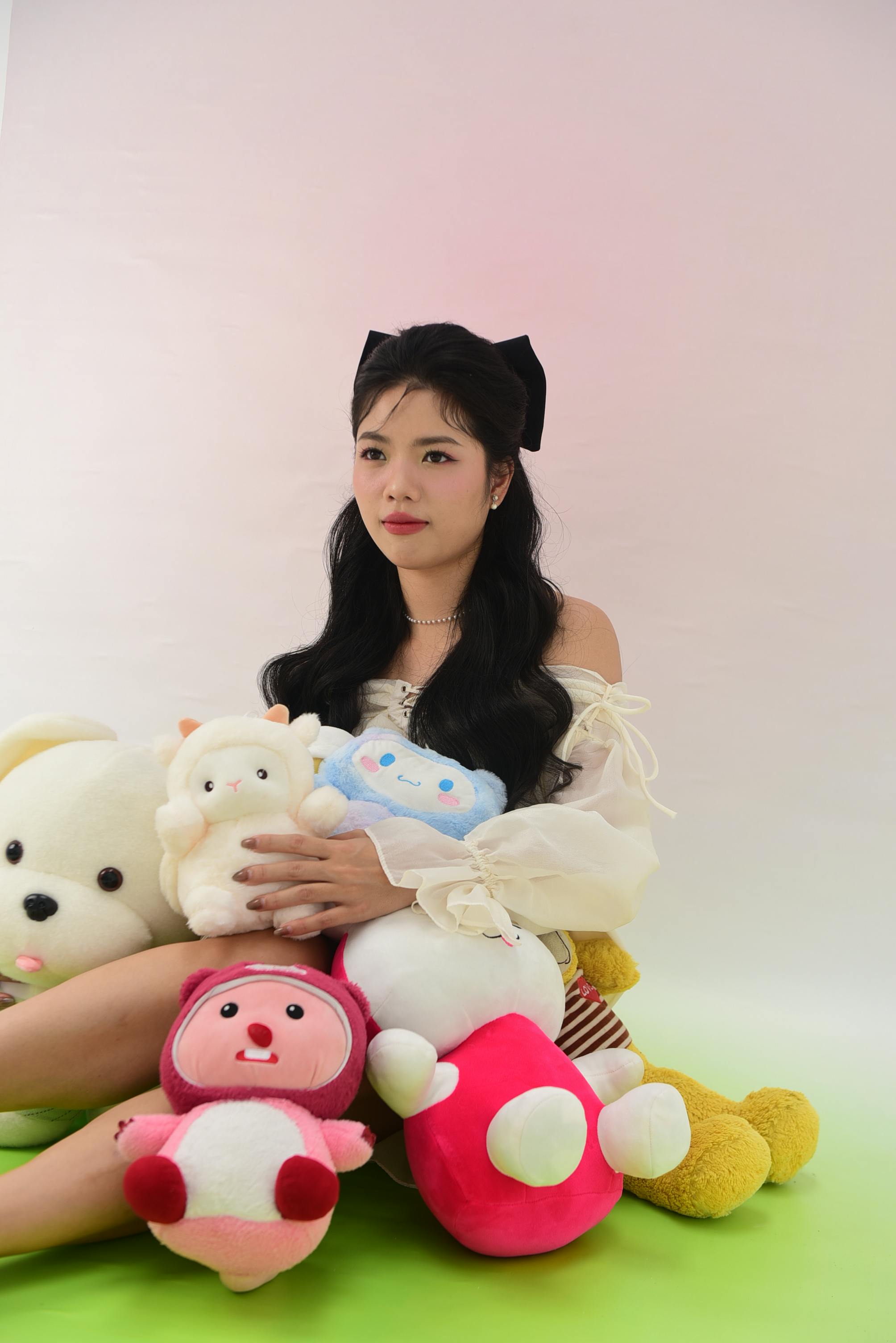 portrait of a brunette sitting with toys