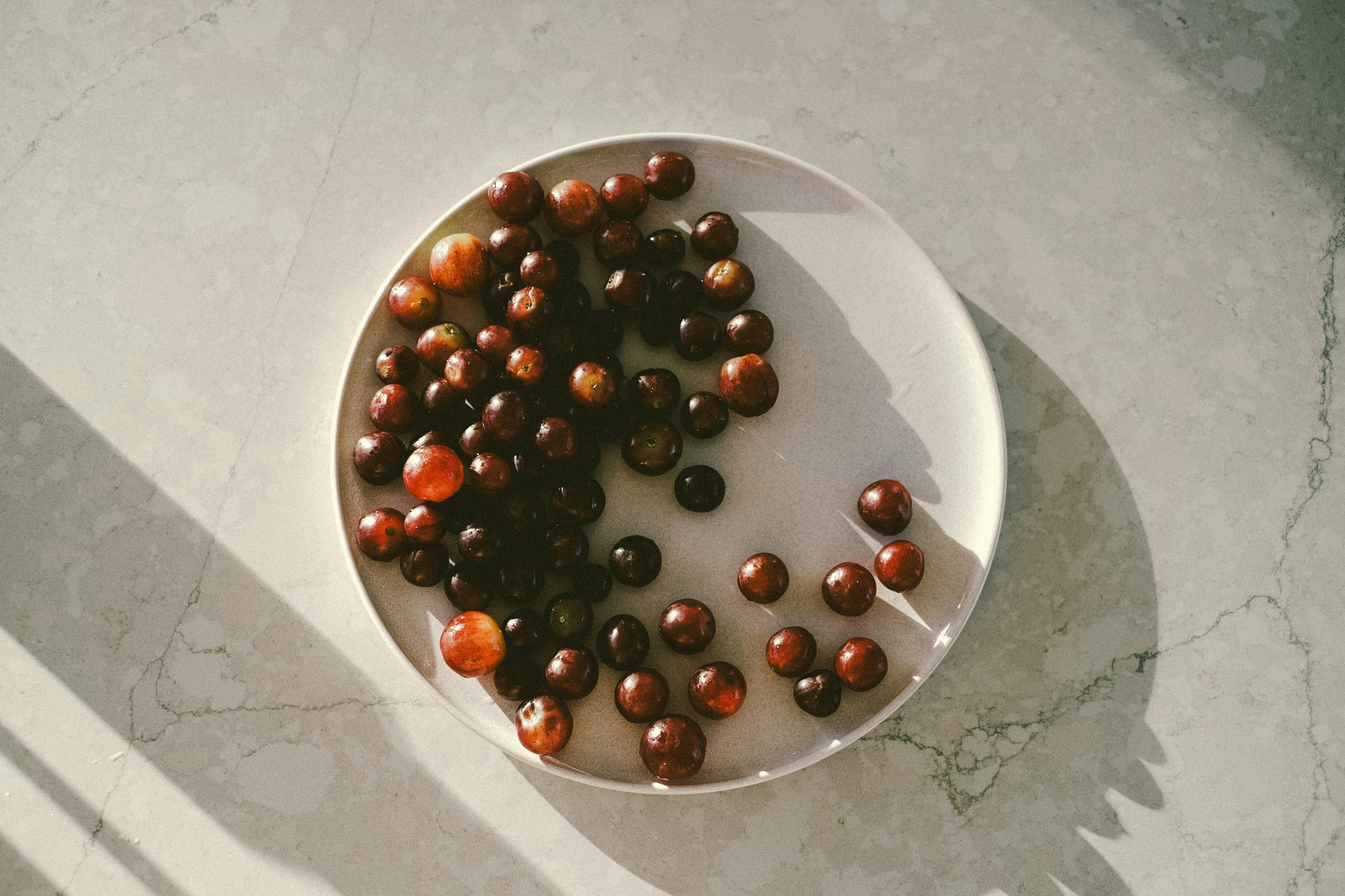 Scenic close-up of ripe cherries on a plate, perfect for summer themes.