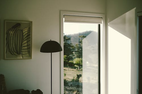 A room with a window and a lamp