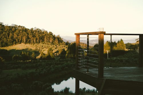 A wooden deck overlooking a lake and mountains