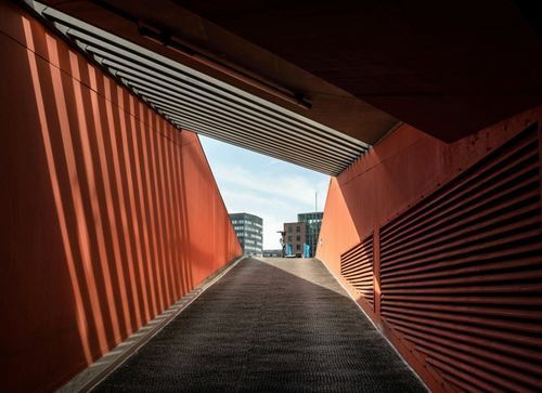 Free A view of a modern tunnel in Hamburg leading to office buildings under a bright sky. Stock Photo