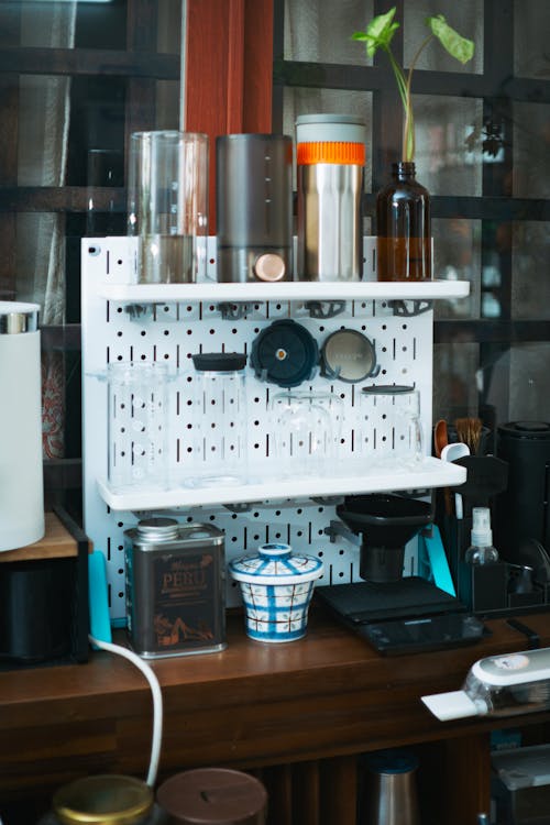 A coffee shop with a shelf full of coffee cups