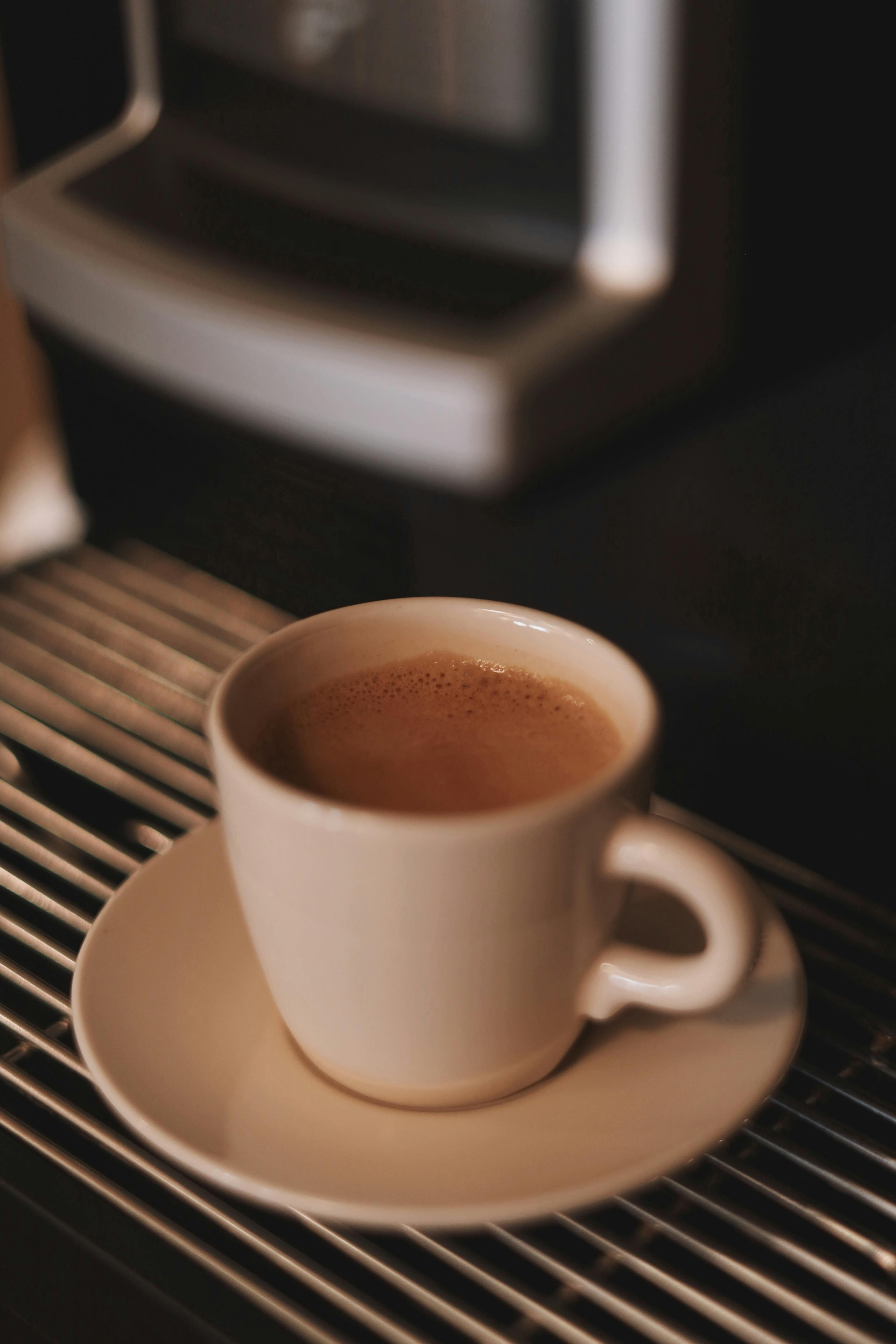 A cozy cup of coffee on a saucer inside a Berlin cafe with soft lighting.