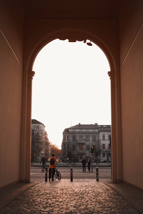 A man and a woman are walking through an archway