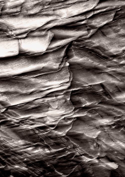 A black and white photo of a rock wall