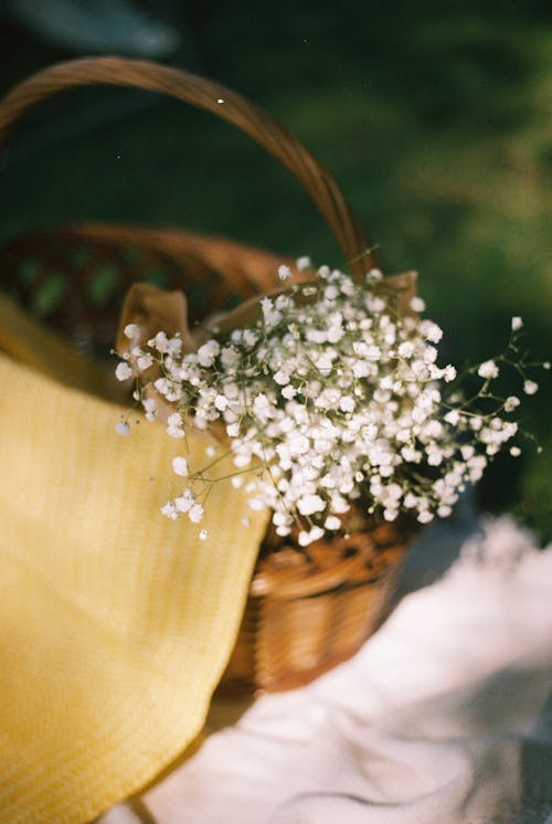 A basket with baby's breath and a yellow blanket