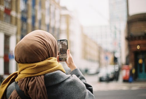 A woman taking a picture of herself with her cell phone