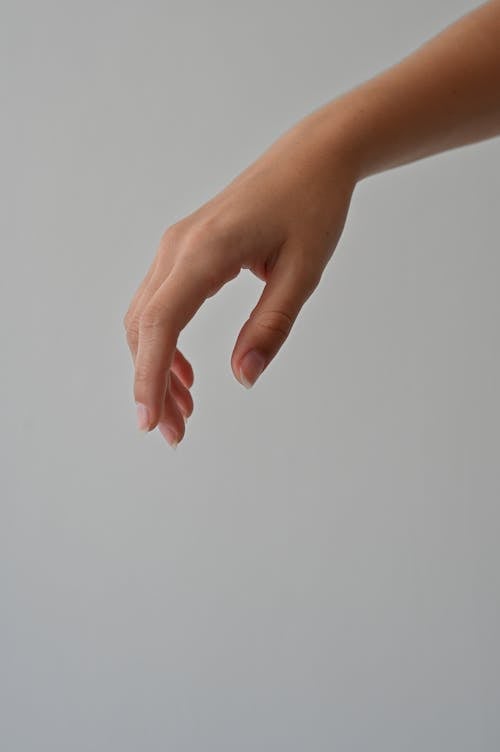 A person's hand reaching out to something