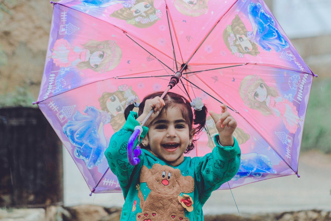 Free Girl Holding an Umbrella Stock Photo