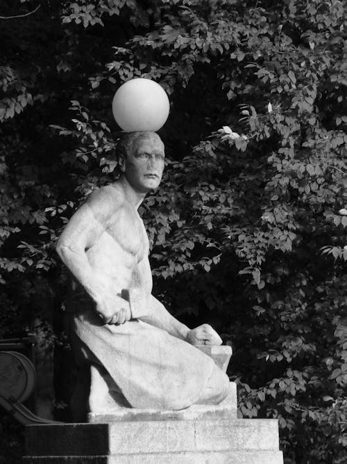 A statue with a ball on top of it