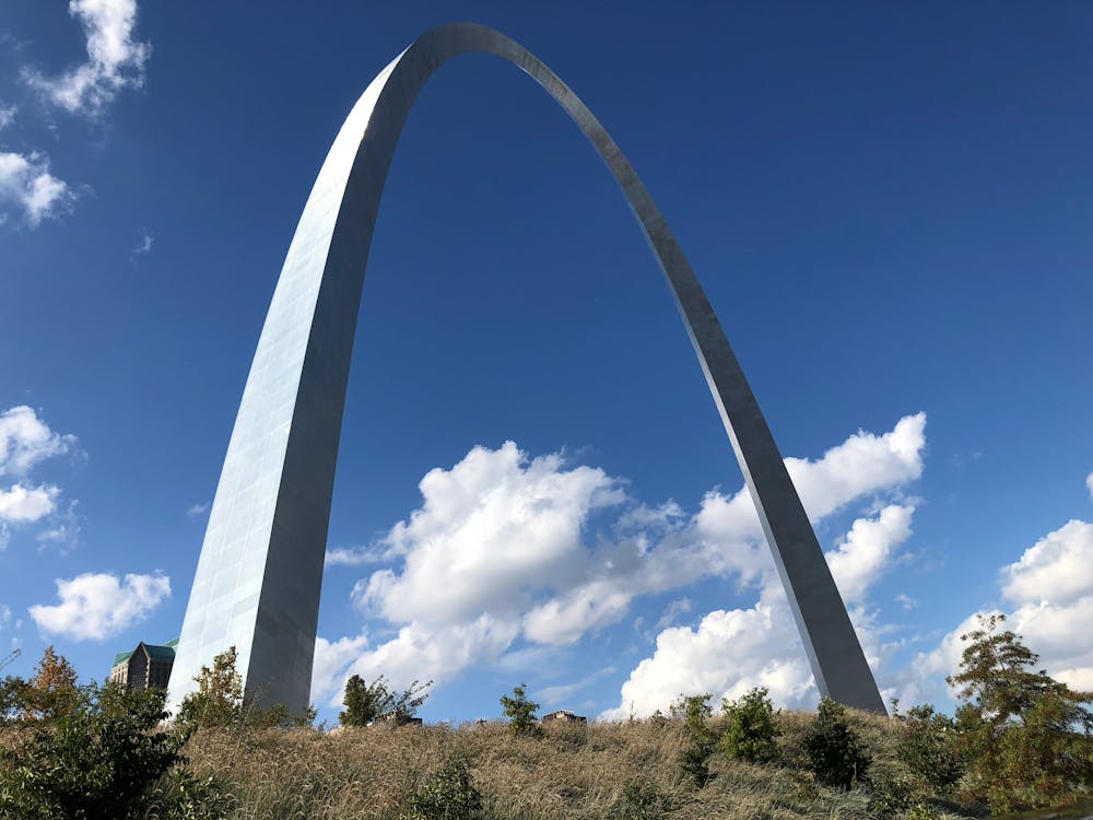 Free Stunning view of the Gateway Arch in St. Louis, Missouri, against a bright blue sky with clouds. Stock Photo
