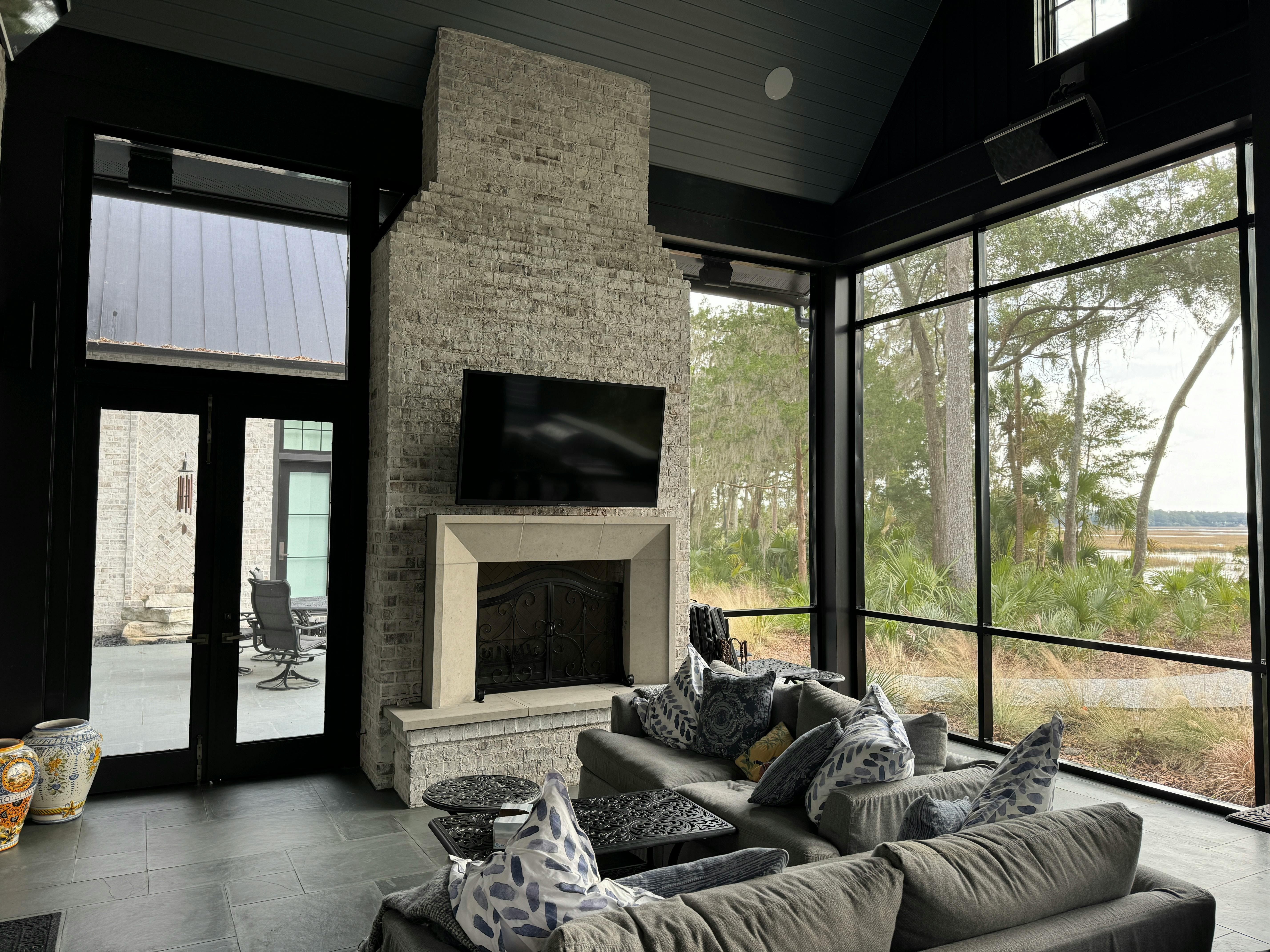 Cozy modern living room in Bluffton, SC featuring a fireplace and outdoor view.
