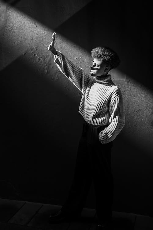 A black and white photo of a person pointing up