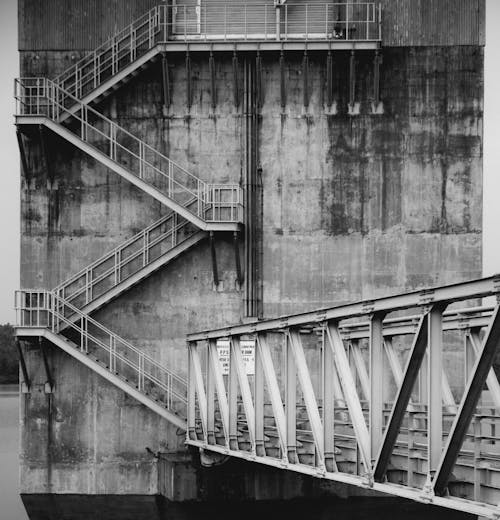 A black and white photo of a concrete wall with stairs