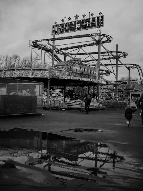 Black and white photo of carnival ride in the rain