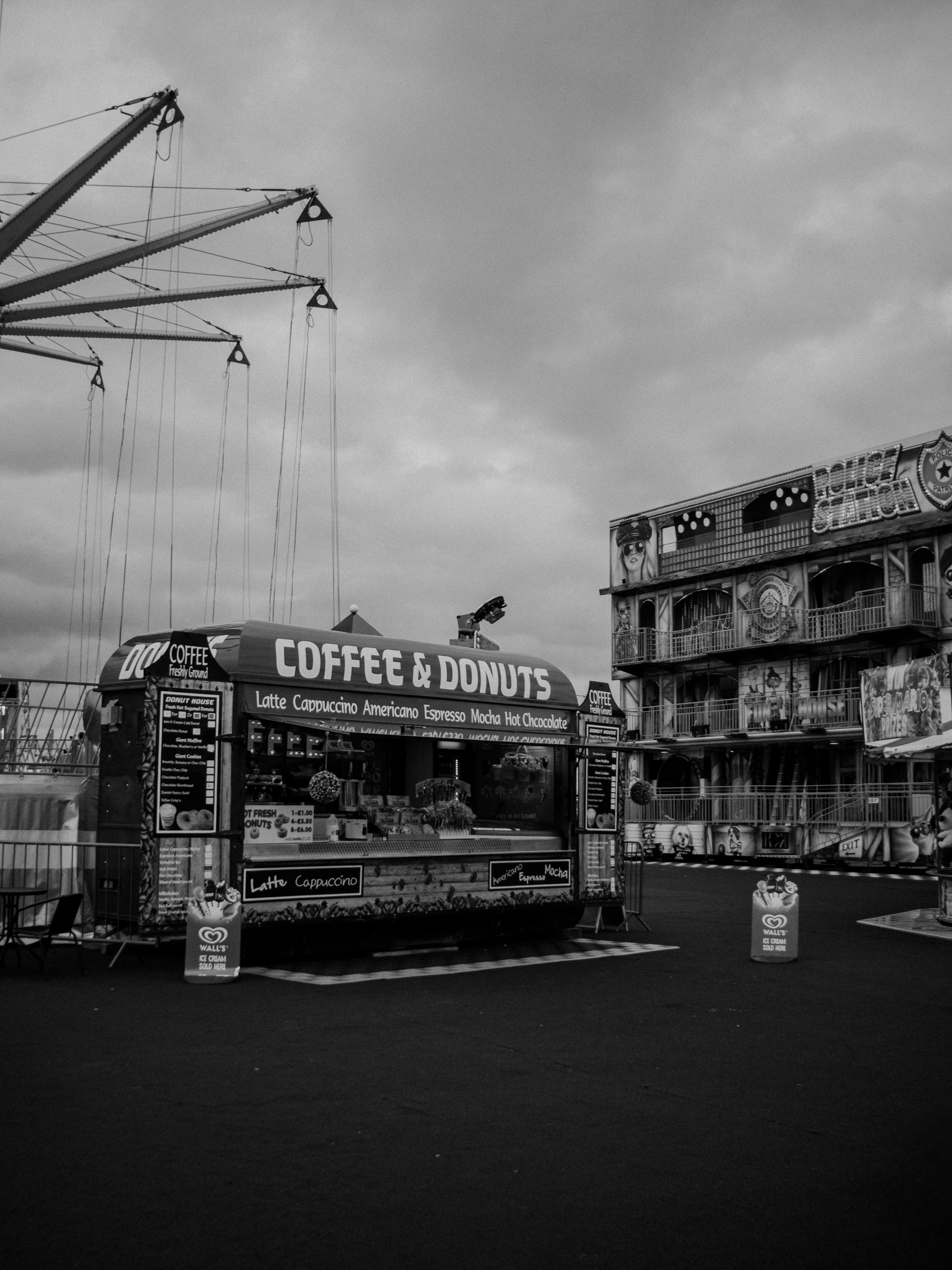 Urban fairground with coffee and donut stand in black and white.