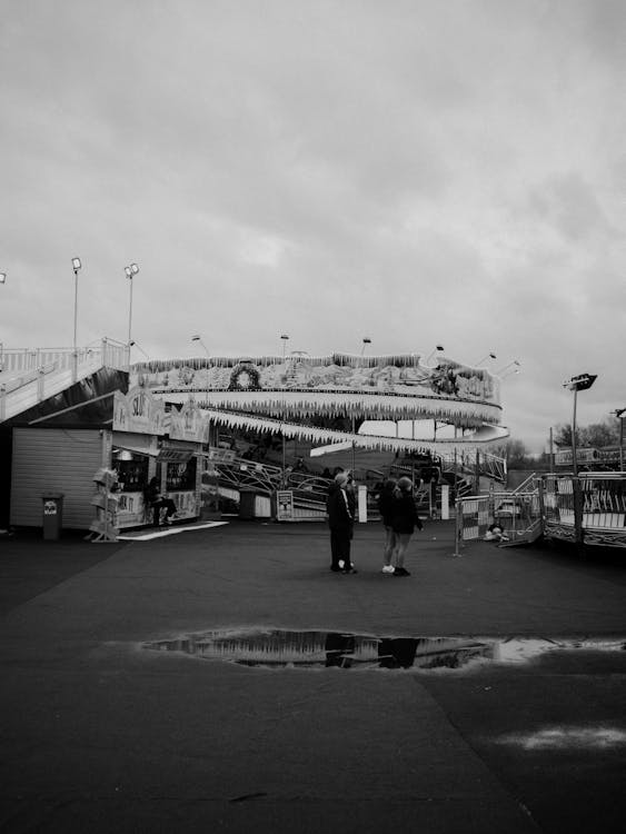 Black and white photo of people walking on a rainy day