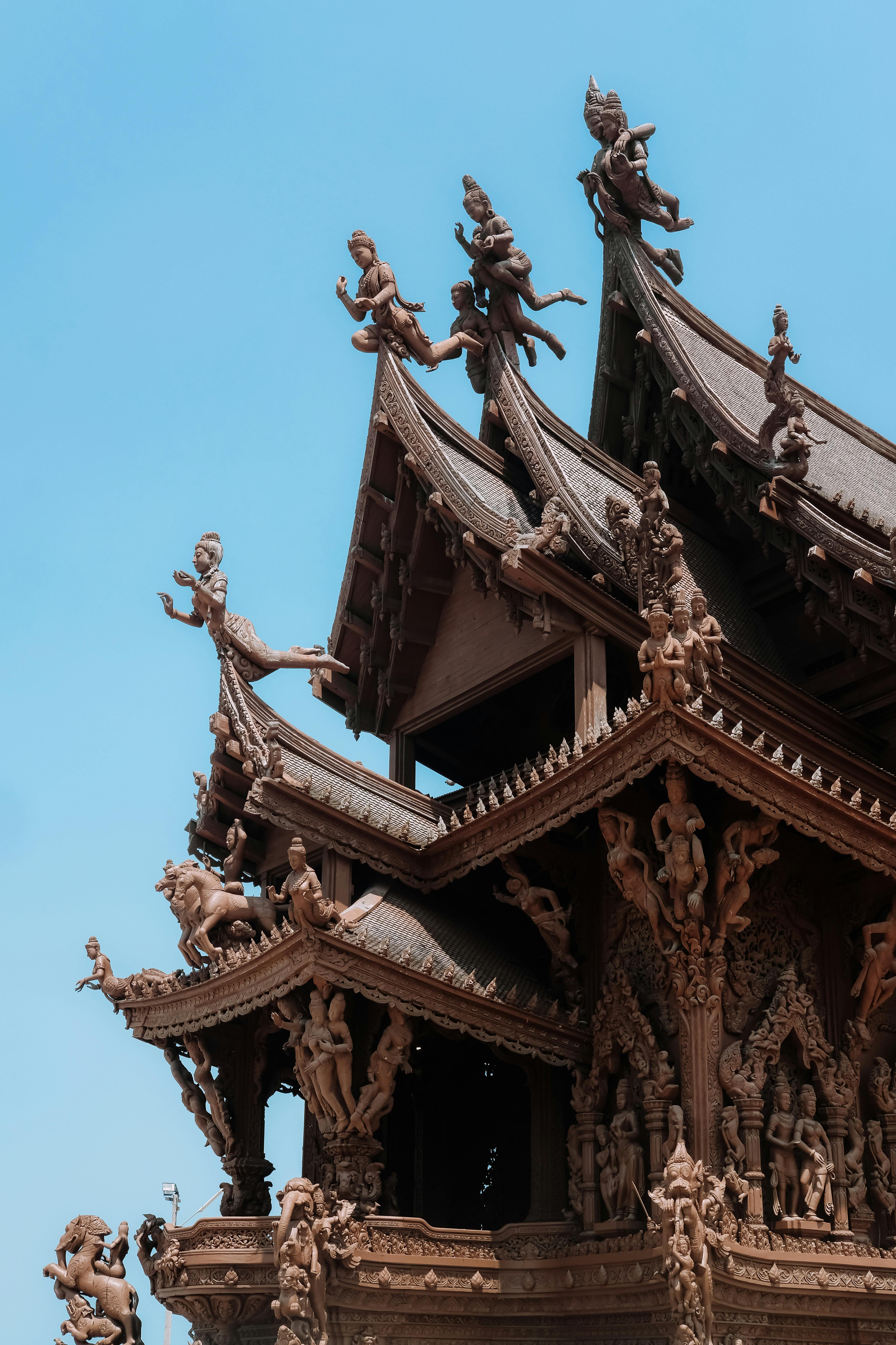 Intricate wooden carvings adorn the Sanctuary of Truth temple in Pattaya, Thailand.