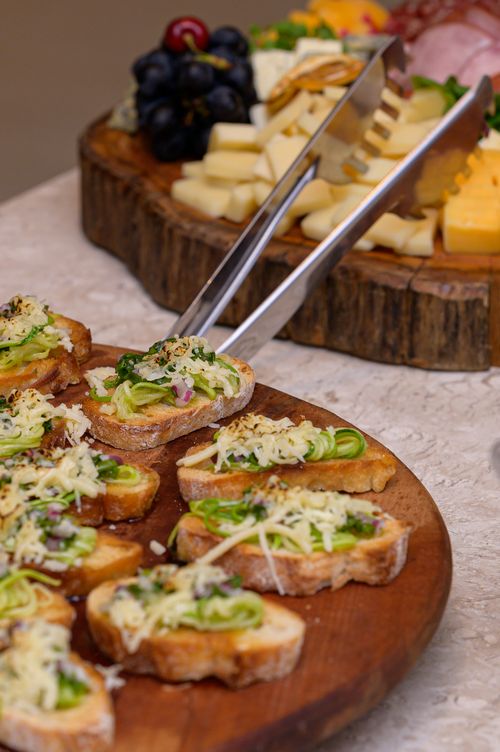 Free Vertical shot of a gourmet charcuterie board featuring canapes, cheese, and grapes. Stock Photo