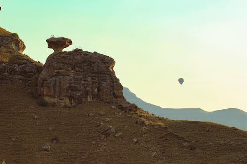 Air balloon in the sky with rocky mountains