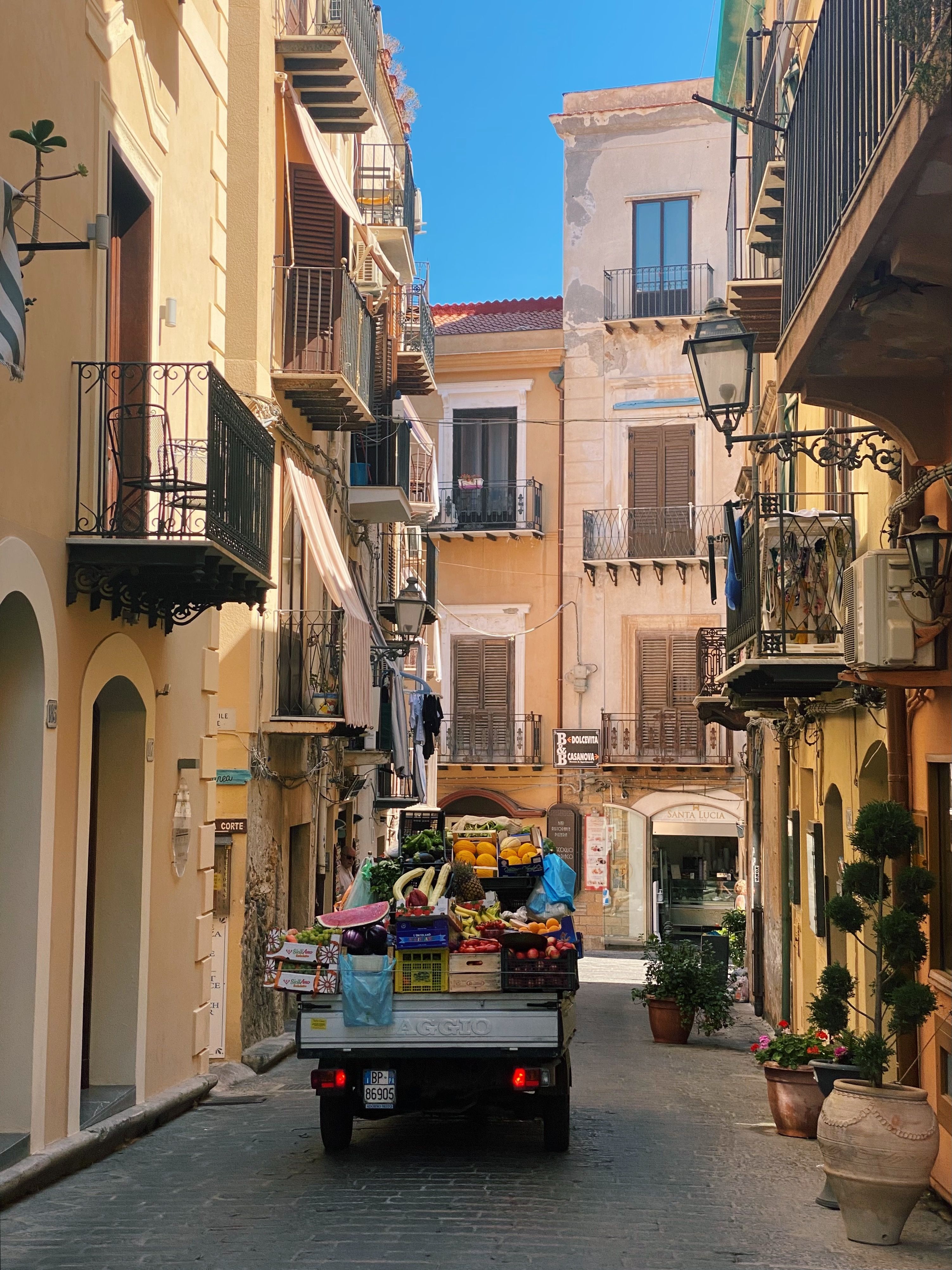 A fruit cart on a narrow street in Cefalu Sicily