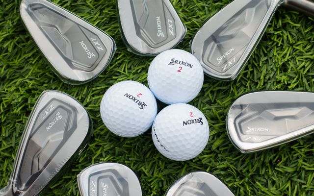 Srixon golf balls among a set of new irons on grass