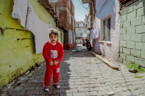 Girl in Red Clothes in Alley in Town