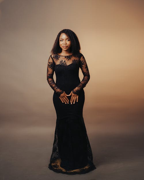 A woman in a black gown posing for a photo
