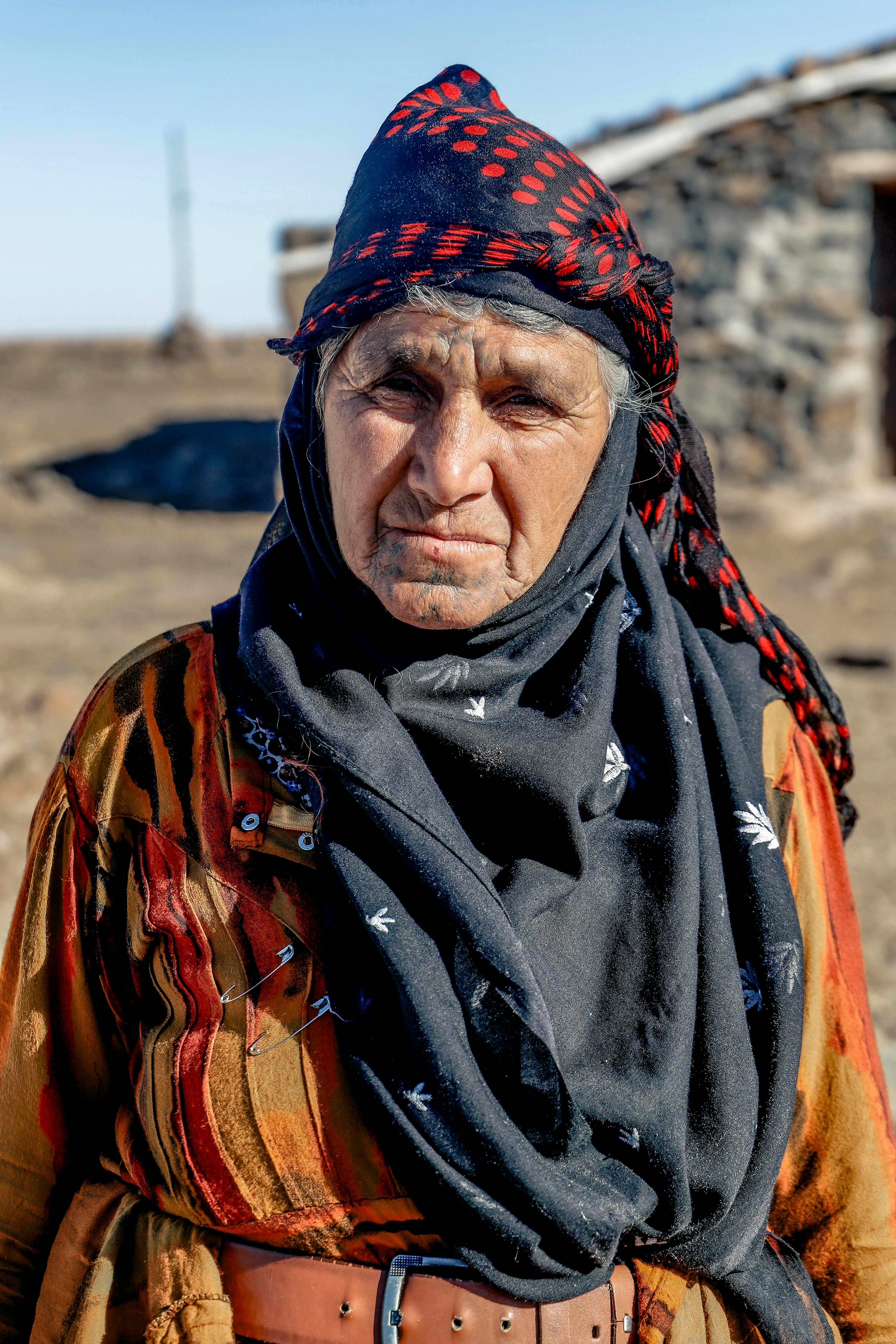 Portrait of an elderly woman wearing traditional attire in the rural area of Mardin, Türkiye.