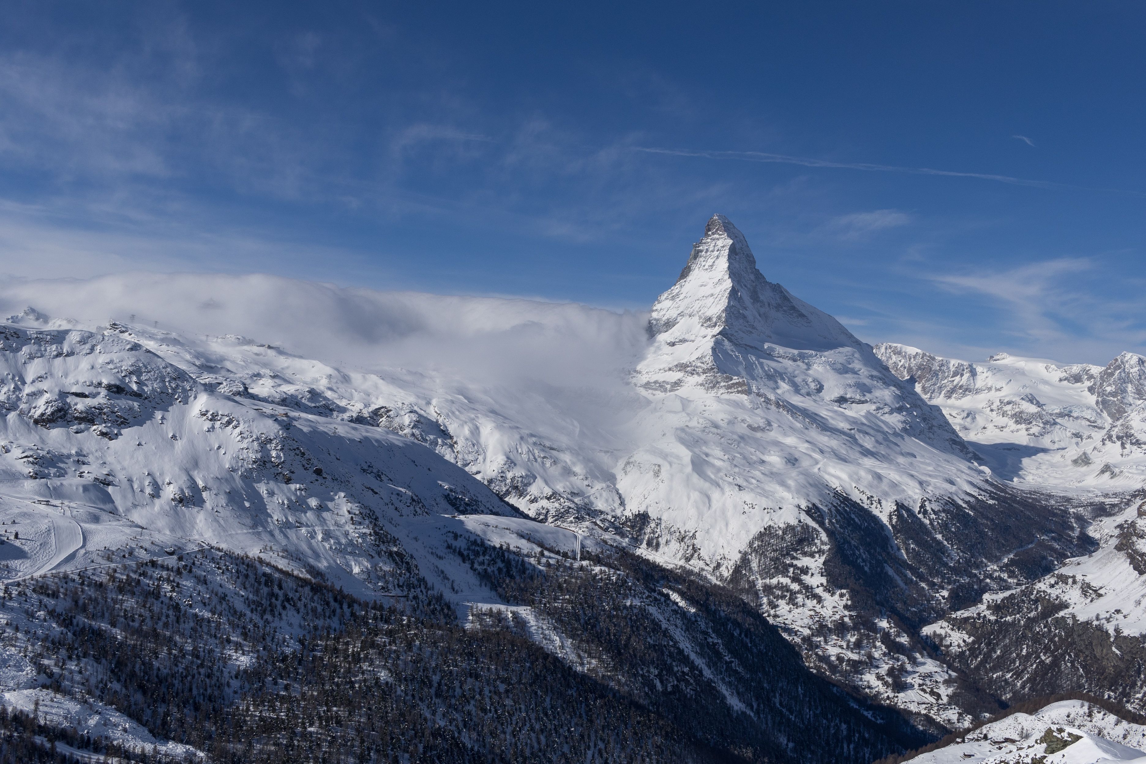 A captivating view of the snowcapped Matterhorn mountain under a clear blue sky in Zermatt, Switzerland.