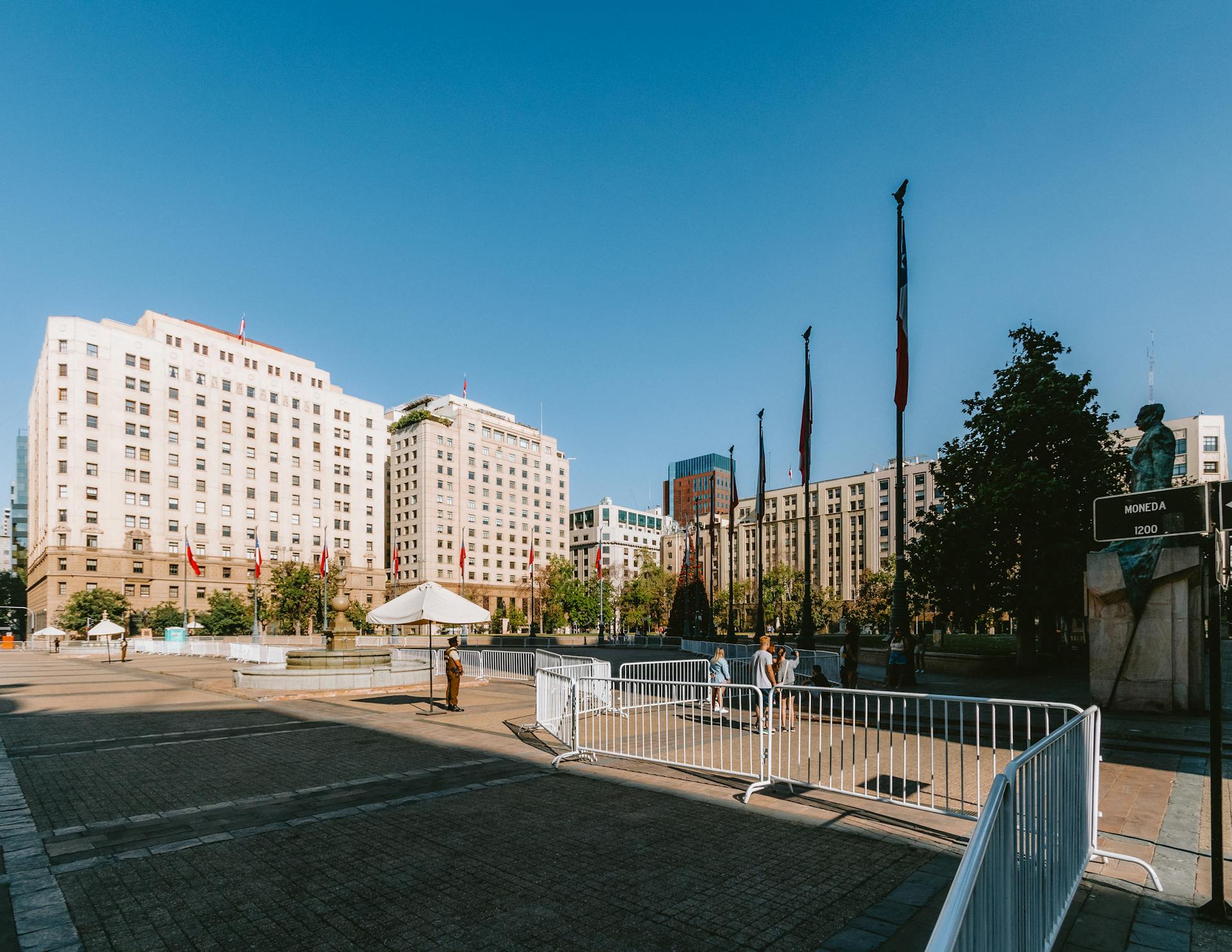 Daytime view of Plaza de la Constitución in Santiago, showcasing architectural landmarks and open urban space.