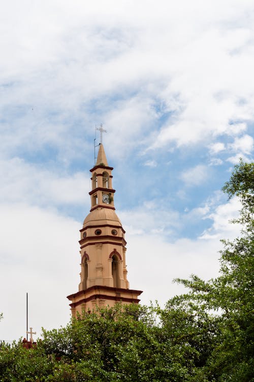 A tall church steeple with a clock on top