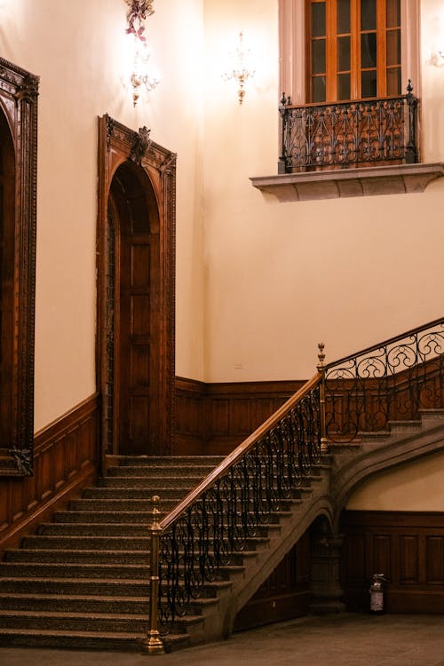 A staircase with ornate woodwork and a light fixture