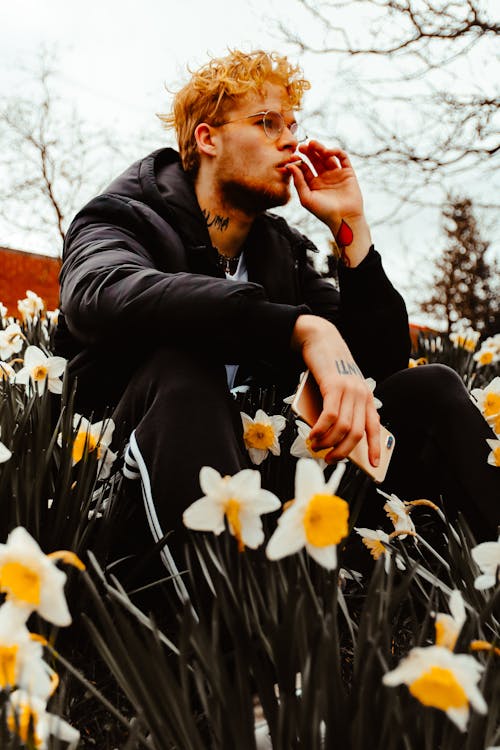 Man Sitting on Field of Flowers