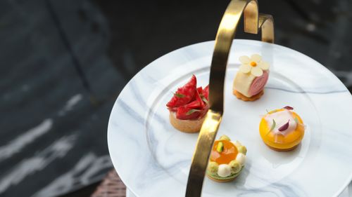 Free Elegant assorted mini cakes with artistic designs on a marble plate, perfect for a stylish dessert presentation. Stock Photo