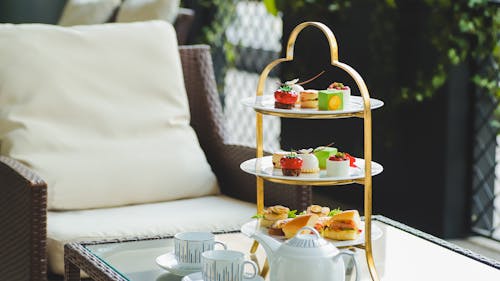 Free A three tiered tray with tea and pastries on it Stock Photo