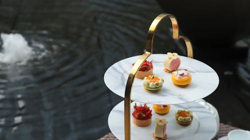 A three tiered tray with desserts on it