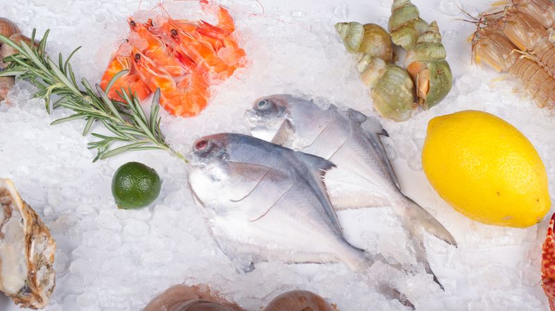 Fresh seafood display with fish, prawns and shellfish on ice