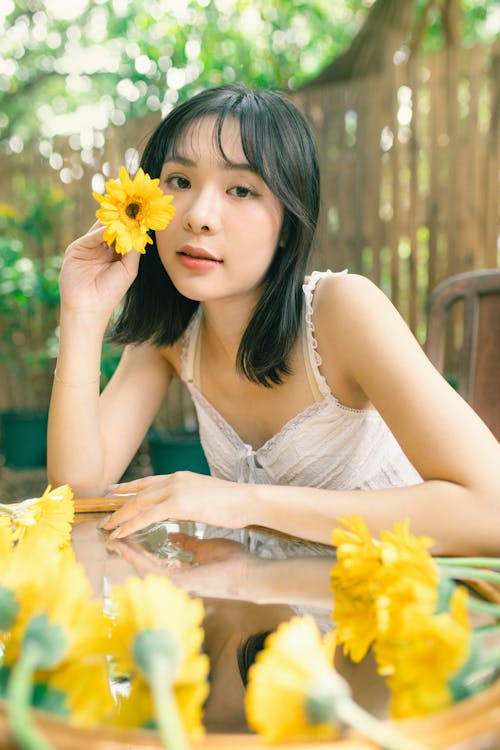 A woman with long hair and yellow flowers