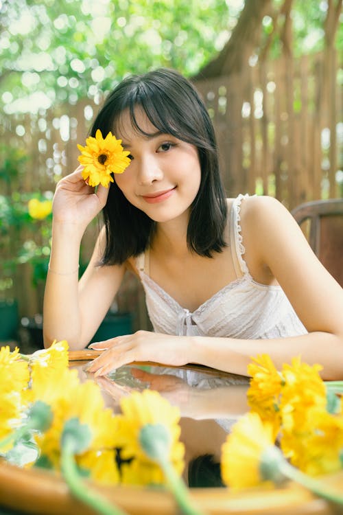 A woman with long hair and yellow flowers