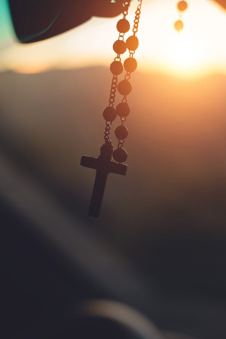 Silhouette Photography Of Hanging Rosary