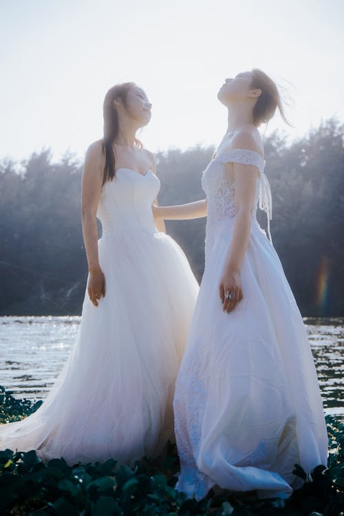 Brunette Women in White Dresses on Lakeshore