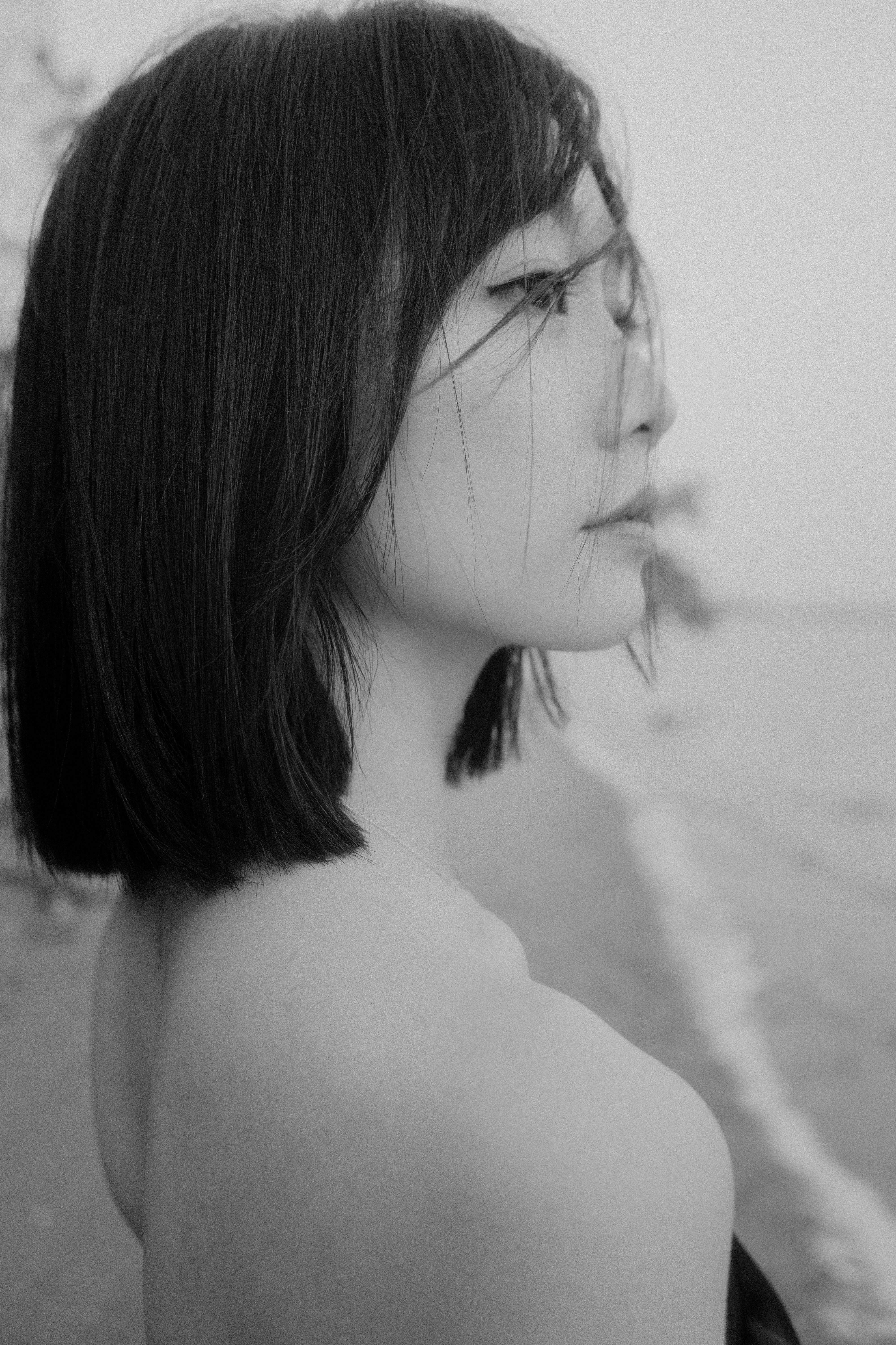 Black and White Photo of a Young Woman Standing on a Beach · Free Stock ...