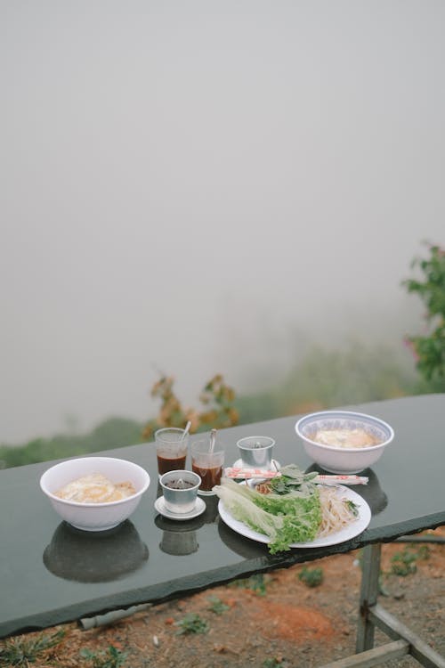 A table with two bowls of food on it