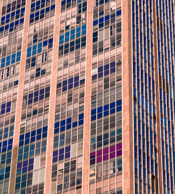 Fotografía De ángulo Bajo De Un Edificio Beige Y Azul